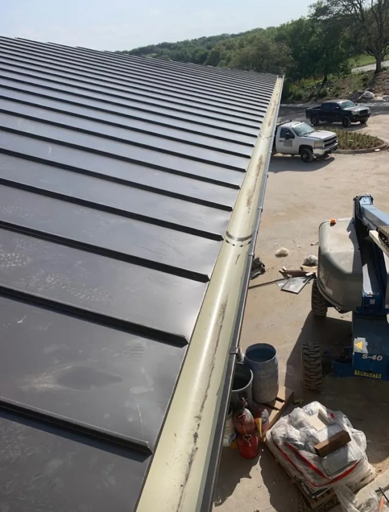 Standing seam panel and gutter detail on a metal roofing jobsite in New Brighton
